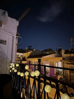 a row of umbrellas on a balcony at night at Corte Panormus in Palermo