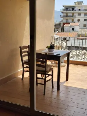 a couch in a living room with a painting on the wall at Terrazze al centro in Palermo