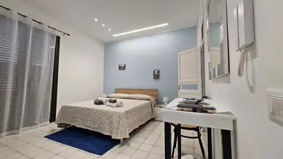a bedroom with a bed and a desk in it at 