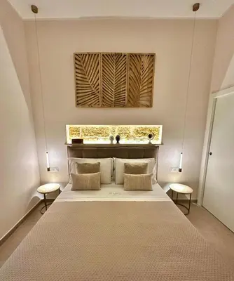 a bedroom with a large bed with two tables at Zisa Suite 2 in Palermo