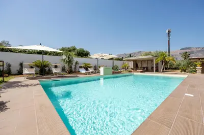 a swimming pool in a resort with mountains in the background at 14th Oasis Family Room In Villa With Pool Near Palermo in Carini