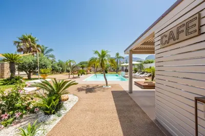 a resort with a swimming pool and a building at 14th Oasis Family Room In Villa With Pool Near Palermo in Carini