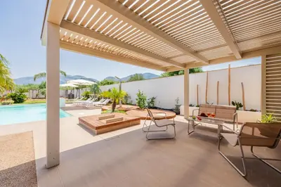 an outdoor patio with a pergola and a pool at 14th Oasis Villa With Private Pool Near Palermo in Carini