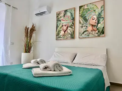 a bedroom with two towels on a bed at Leonetti Due in Carini