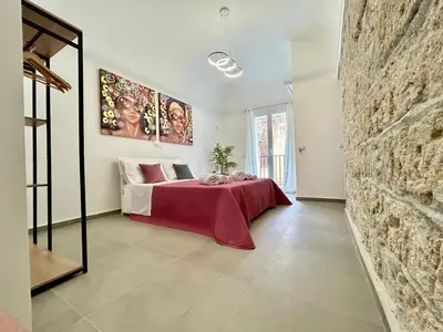 a bedroom with a bed with a red blanket at Leonetti Due in Carini