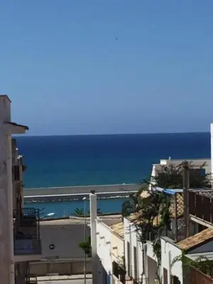 a view of the ocean from a city with buildings at Dall'Orso Grigio in Balestrate