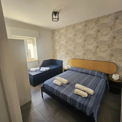 a bedroom with a bed with two towels on it at Hakuna matata in Terrasini