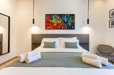 a bedroom with a bed with a painting on the wall at Capo D'Amuri in Palermo