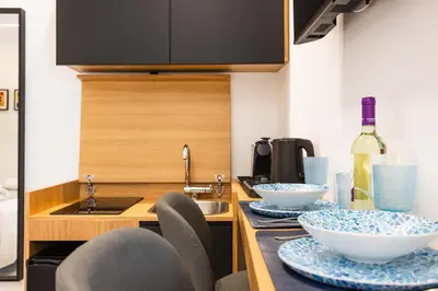 a kitchen with a counter with bowls and a sink at Capo D'Amuri in Palermo