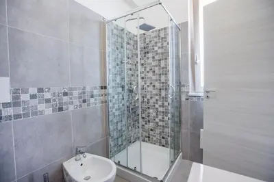 a bathroom with a shower and a toilet and a sink at Belvedere Rent Rooms in Campofelice di Roccella