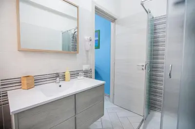 a bathroom with a sink and a shower at Belvedere Rent Rooms in Campofelice di Roccella