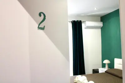 a room with a door with a number two on the wall at Rooms, eleganza moderna nel centro storico di Palermo in Palermo