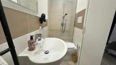 a bathroom with a sink and a shower at Rooms, eleganza moderna nel centro storico di Palermo in Palermo