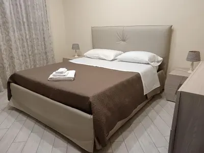 a bedroom with a large bed with two towels on it at La casa di Marió in Palermo