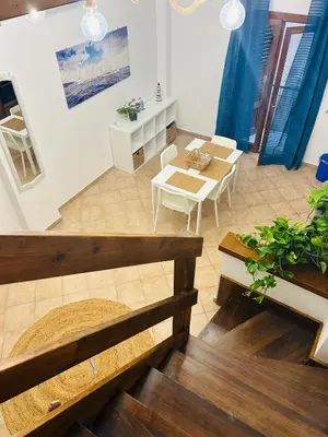 a living room with a table and a dining room at Mercede rooms Ballaró in Palermo