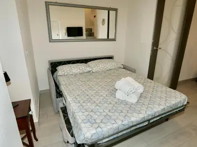 a bed with towels on it in a room at Casetta al Duomo in Monreale