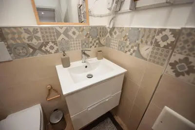 a bathroom with a sink and a toilet at Holiday House Annunziata 1 in Termini Imerese
