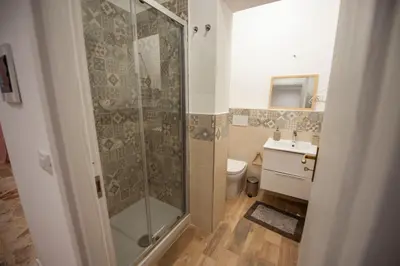 a bathroom with a shower and a toilet and a sink at Holiday House Annunziata 1 in Termini Imerese