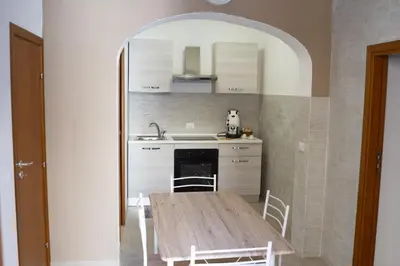 a kitchen with a wooden table in a room at Casa Verdi in Capaci
