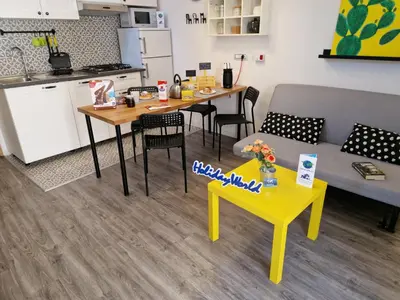 a living room with a yellow table and a couch at Il Fico d'India by Holiday World in Palermo