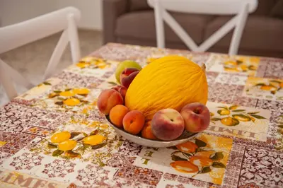 a bowl of fruit sitting on top of a table at Holiday House Annunziata in Termini Imerese