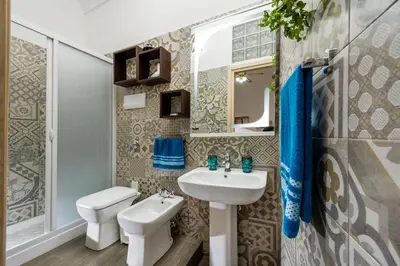 a bathroom with a sink and a toilet at Oasi del Libro in Castellammare del Golfo