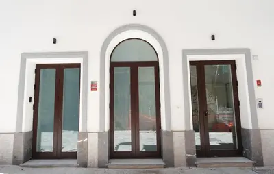 three glass doors on the side of a building at Eccelso Case Vacanza in Palermo