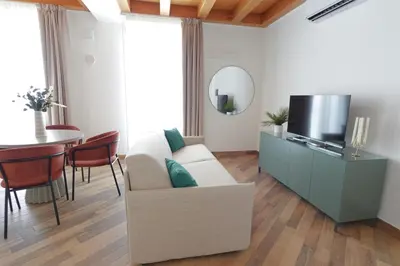 a living room with a couch and a tv and a table at Eccelso Case Vacanza in Palermo