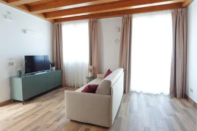 a living room with a couch and a television at Eccelso Case Vacanza in Palermo