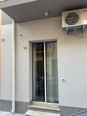 a building with a glass door on the side of it at A due passi in Balestrate