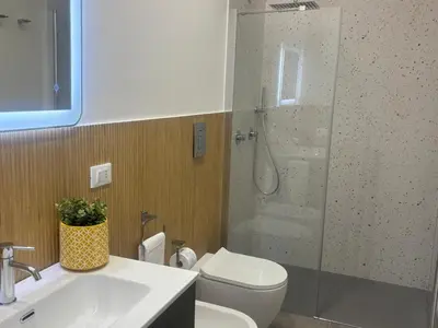 a bathroom with a shower and a toilet and a sink at A due passi in Balestrate