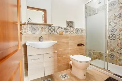 a bathroom with a toilet and a sink and a shower at A 2 passi dal Teatro Massimo in Palermo