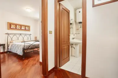a bedroom with a bed and a door leading to a bathroom at A 2 passi dal Teatro Massimo in Palermo