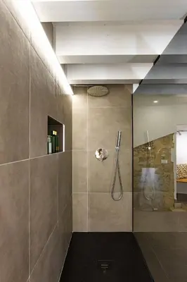 a bathroom with a shower with a glass door at La Camera di Carolino in Palermo
