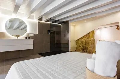 a bedroom with a bed and a mirror at La Camera di Carolino in Palermo