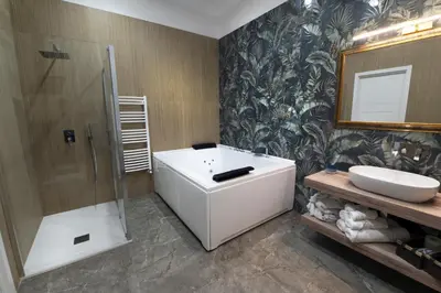 a bathroom with a tub and a sink and a shower at Fervore Luxury Rooms-Apartments in Palermo