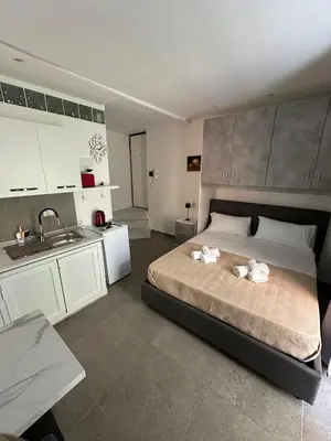 a bedroom with a large bed and a sink at A casa di Maria in Palermo