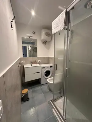 a bathroom with a shower and a toilet and a sink at A casa di Maria in Palermo