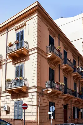 a building with balconies and windows with plants on them at Palermo al Centro - Appartamento Fiume in Palermo