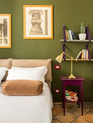 a bedroom with a bed and a table with a lamp at Cassaro261 in Palermo