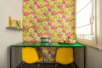 a green table with two yellow chairs in a room at Cassaro261 in Palermo