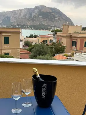 a bottle of champagne sitting on a table with two wine glasses at Le Lunette Holiday House in Palermo