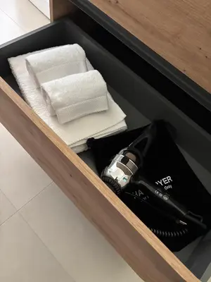 a drawer with towels and a hair dryer in it at Le Lunette Holiday House in Palermo