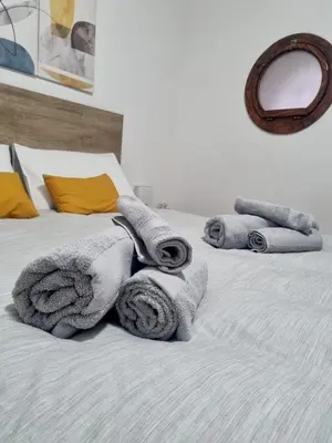 a bedroom with a bed with towels on it at Casa Marì-Albergheria in Palermo's historic center in Palermo