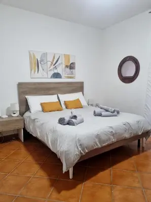 a bed in a bedroom with two people laying on it at Casa Marì-Albergheria in Palermo's historic center in Palermo