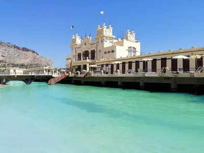 a building on a bridge over a river at La casetta di Totò in Palermo