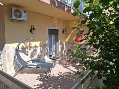 a chair sitting on the porch of a house at Casa Lety in Palermo