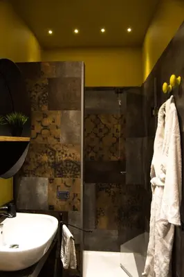 a bathroom with a sink and a toilet and a shower at Home In City in Palermo
