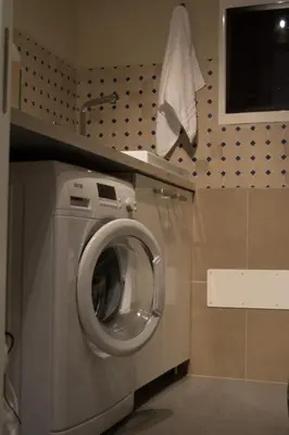 a washing machine in a kitchen with a counter at Home In City in Palermo