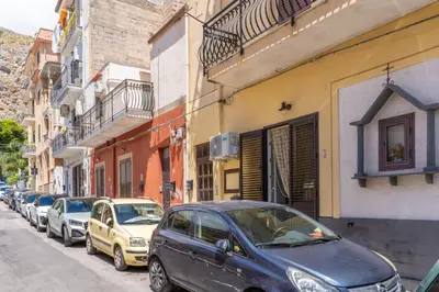 a row of cars parked on the side of a street at Antony Mondello Guest House, appartamento a 1 minuto a piedi dalla spiaggia di Mondello in Palermo
